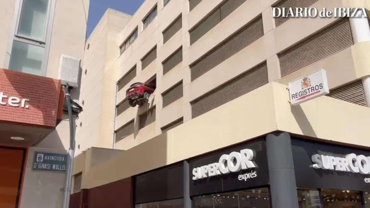 A car is left hanging from a fourth floor of a parking lot in Ibiza