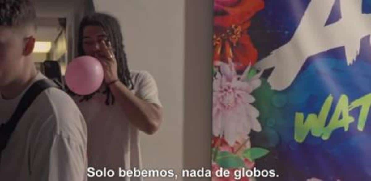 A boy takes laughing gas in a balloon